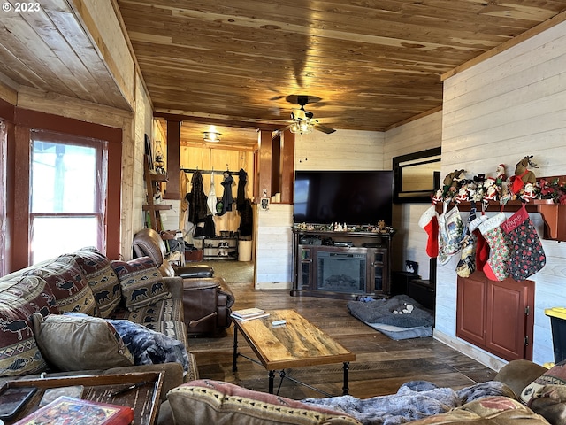 living room featuring dark wood-type flooring, ceiling fan, wooden walls, and wooden ceiling