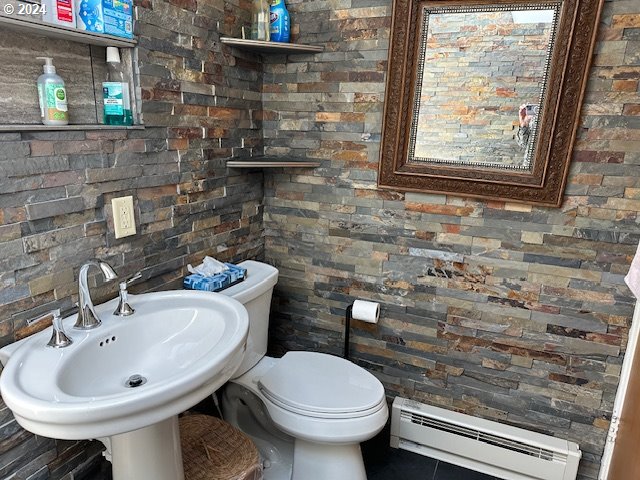 bathroom featuring toilet, sink, tile patterned floors, and a baseboard radiator