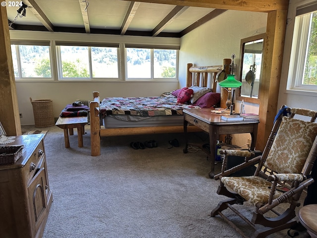 carpeted bedroom with beamed ceiling