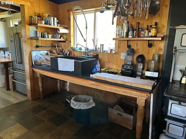 misc room featuring wood walls and sink