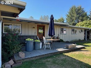 rear view of property featuring a lawn and a patio