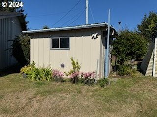 view of property exterior with a shed and a yard