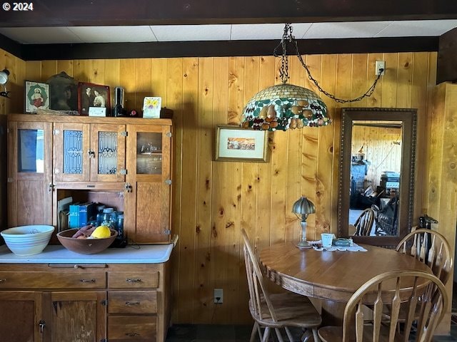 dining space with wooden walls