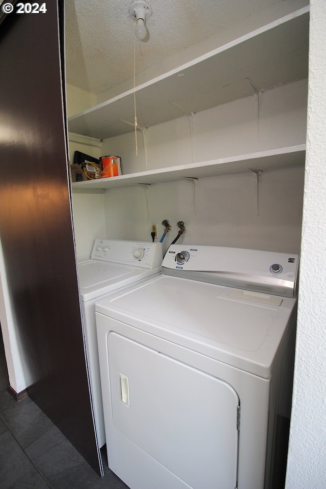 laundry room featuring separate washer and dryer and a textured ceiling