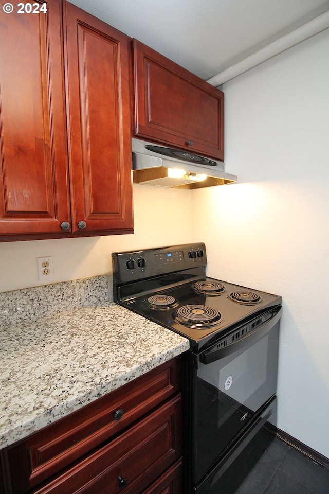 kitchen with black electric range oven and light stone counters