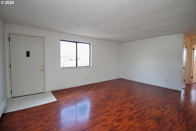 interior space featuring hardwood / wood-style flooring and a textured ceiling