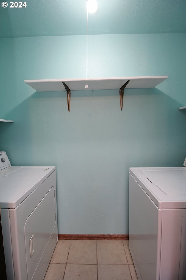 washroom featuring washer / clothes dryer and light tile patterned floors