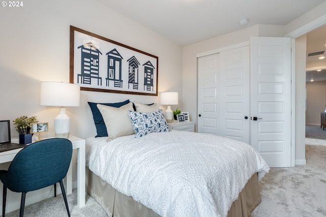 bedroom with light carpet and a closet