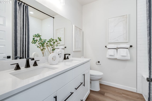 bathroom with vanity, hardwood / wood-style floors, and toilet