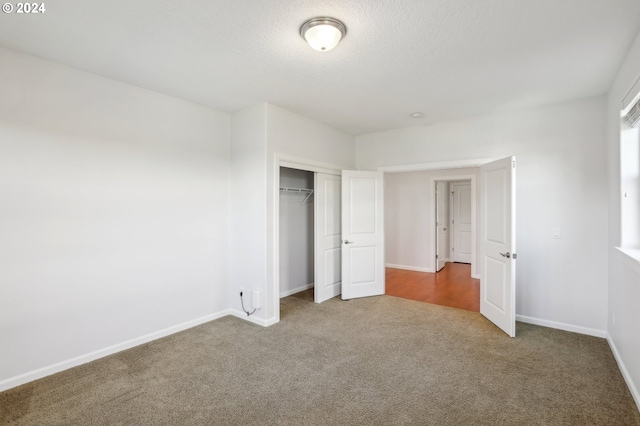 unfurnished bedroom featuring a closet and carpet floors