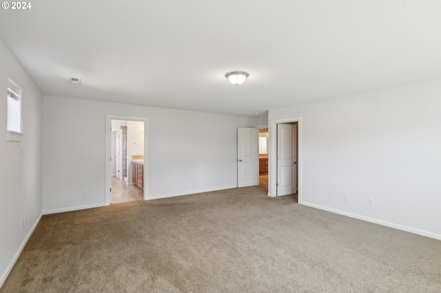 unfurnished room with light colored carpet