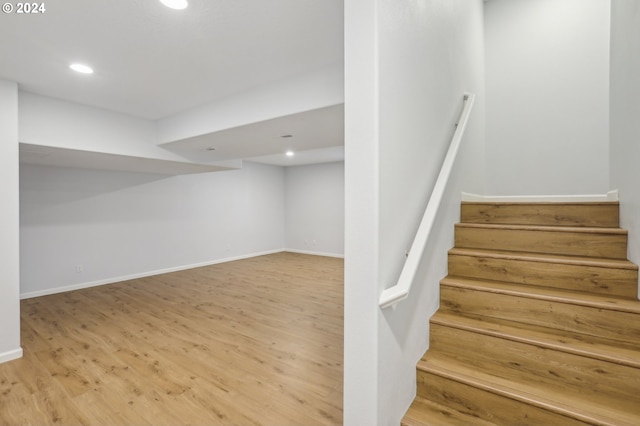 stairway with hardwood / wood-style flooring