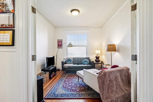 living room with wood-type flooring and crown molding