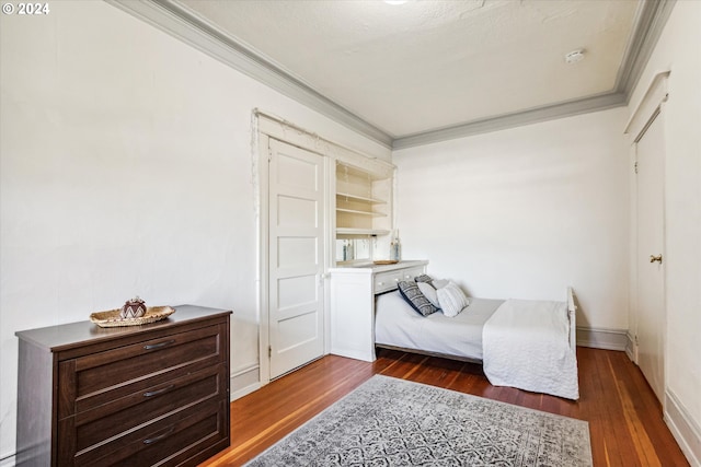 bedroom featuring dark wood-type flooring and ornamental molding