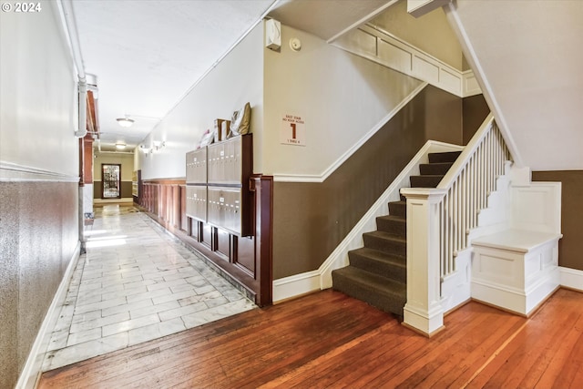 stairs with wood-type flooring and lofted ceiling