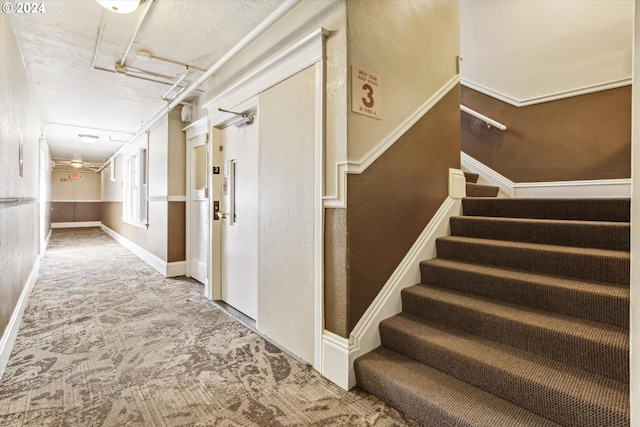 staircase with carpet flooring and crown molding