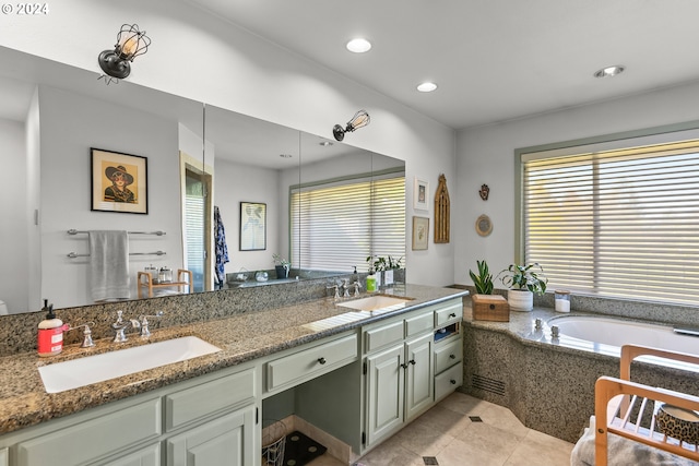 bathroom featuring dual bowl vanity, tile flooring, tiled tub, and plenty of natural light