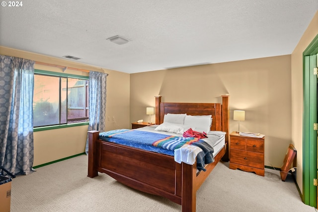 bedroom with carpet and a textured ceiling