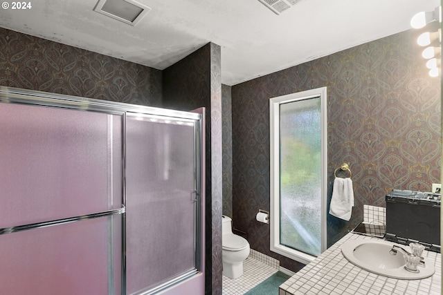 bathroom with tile flooring, vanity, and toilet