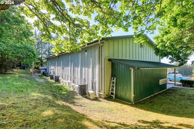 view of shed / structure with a lawn and central AC