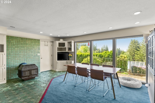 tiled dining area featuring a textured ceiling