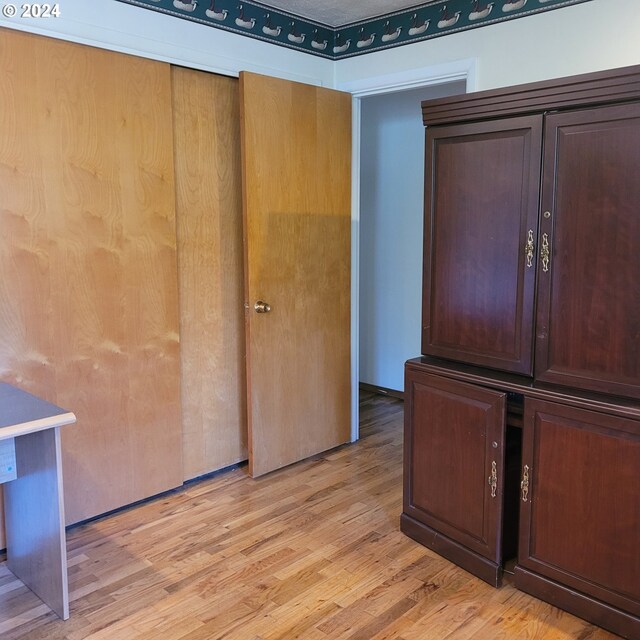 unfurnished room with light wood-type flooring