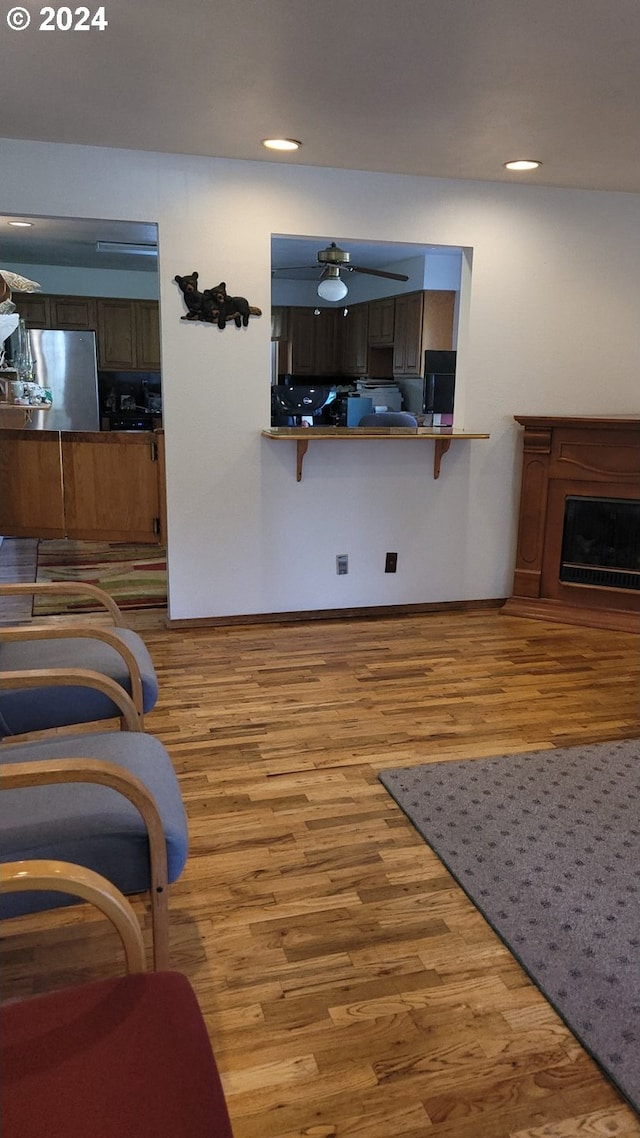 living room featuring ceiling fan and light wood-type flooring