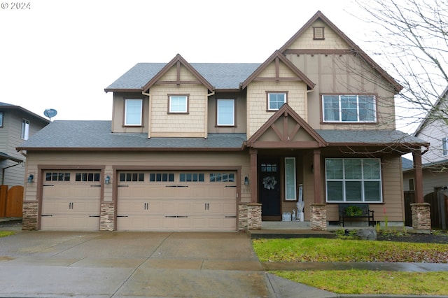 craftsman inspired home featuring covered porch and a garage