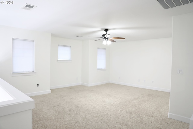 empty room with light colored carpet and ceiling fan