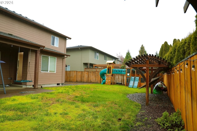 view of yard featuring a trampoline and a playground