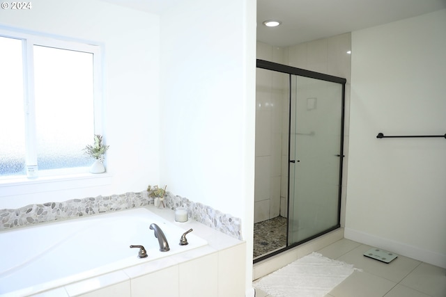 bathroom with tile patterned floors and independent shower and bath