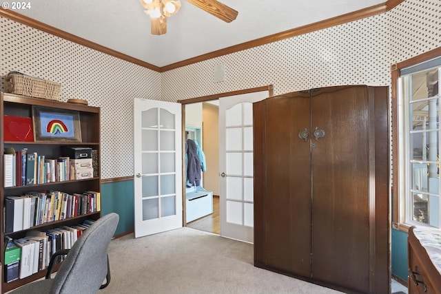 carpeted office space with crown molding, french doors, and ceiling fan