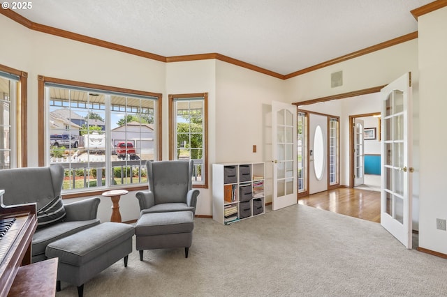 living area with french doors, carpet flooring, ornamental molding, and baseboards