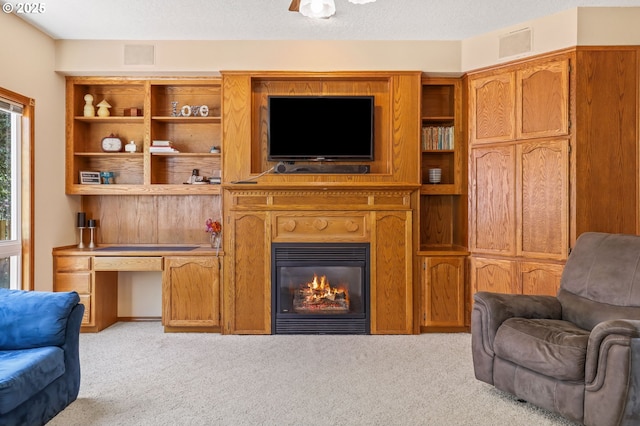 living room with light carpet and a glass covered fireplace