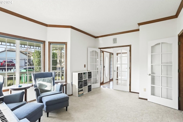 sitting room featuring carpet floors, crown molding, and french doors