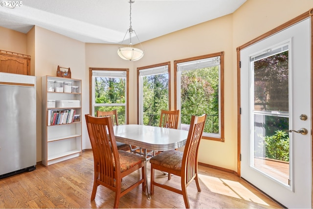 dining room with light wood-style flooring and baseboards