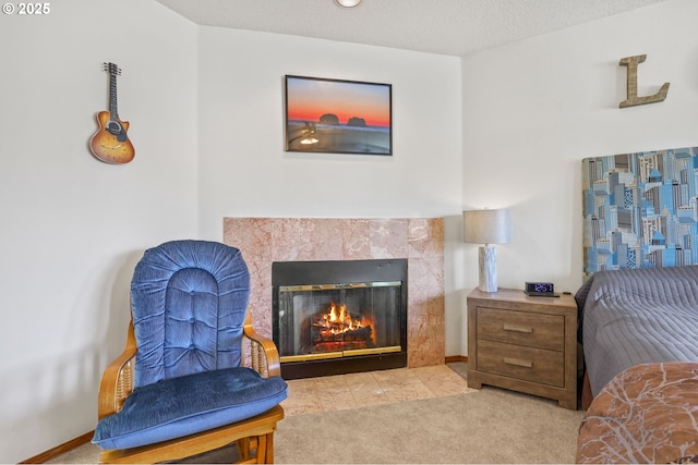carpeted bedroom featuring a tile fireplace