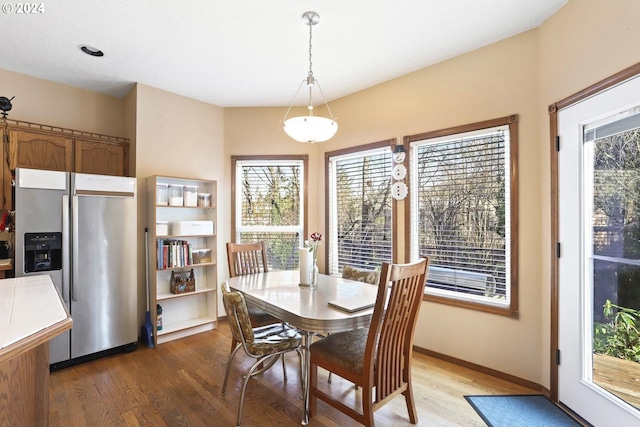 dining space with hardwood / wood-style floors