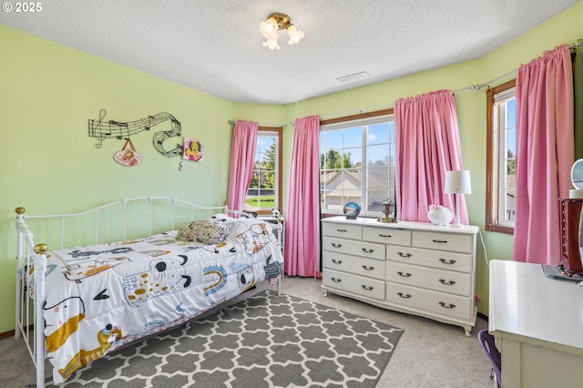 carpeted bedroom with a textured ceiling