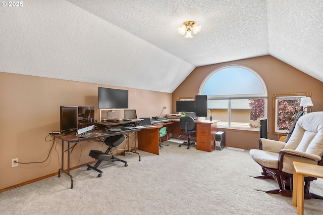 office area featuring a textured ceiling, lofted ceiling, carpet floors, and baseboards
