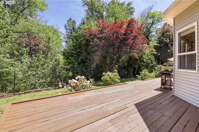 deck featuring grilling area and fence