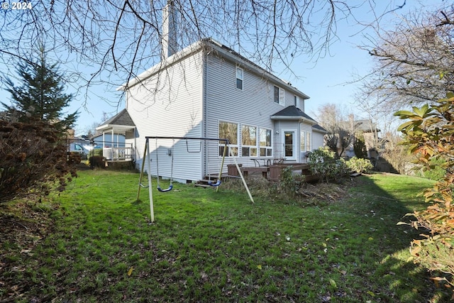 back of house with a yard and a wooden deck