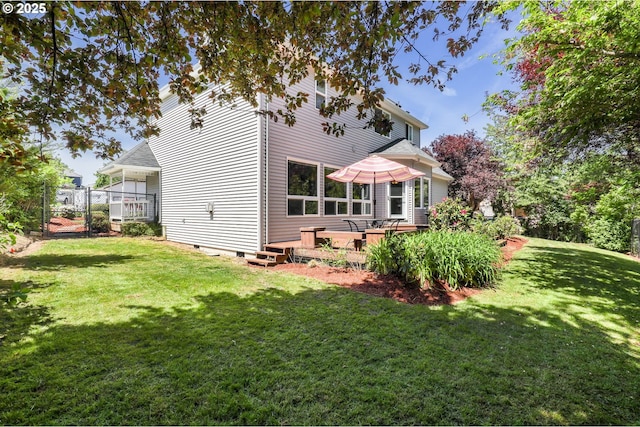 rear view of property featuring crawl space and a yard