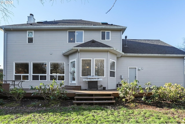 back of property featuring a wooden deck