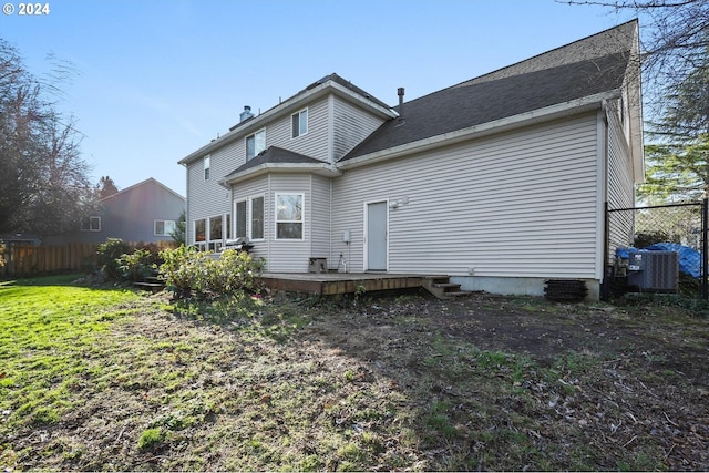 rear view of property with a yard, central AC, and a wooden deck