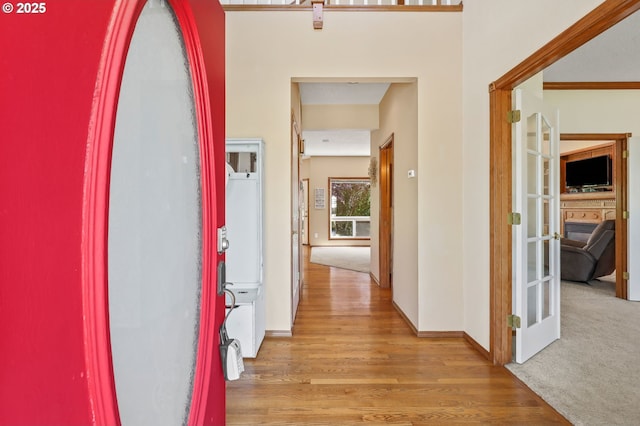 hallway with light wood-style floors and baseboards