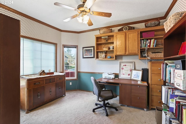 carpeted home office with crown molding, ceiling fan, and a textured ceiling