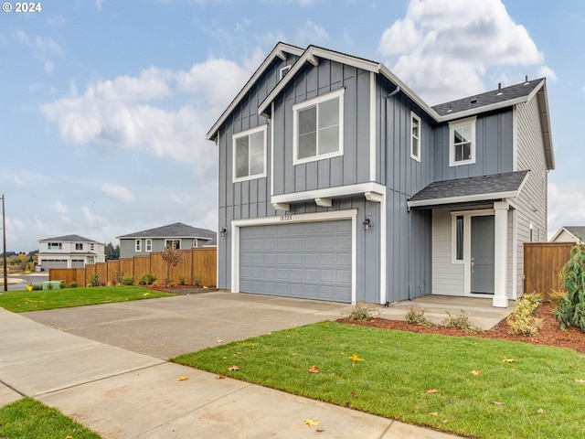 view of front of property featuring a front lawn and a garage