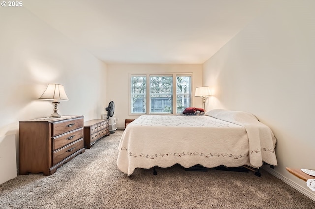 bedroom featuring light colored carpet and baseboards