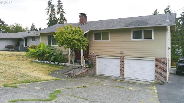 view of front of house with a garage and a front yard